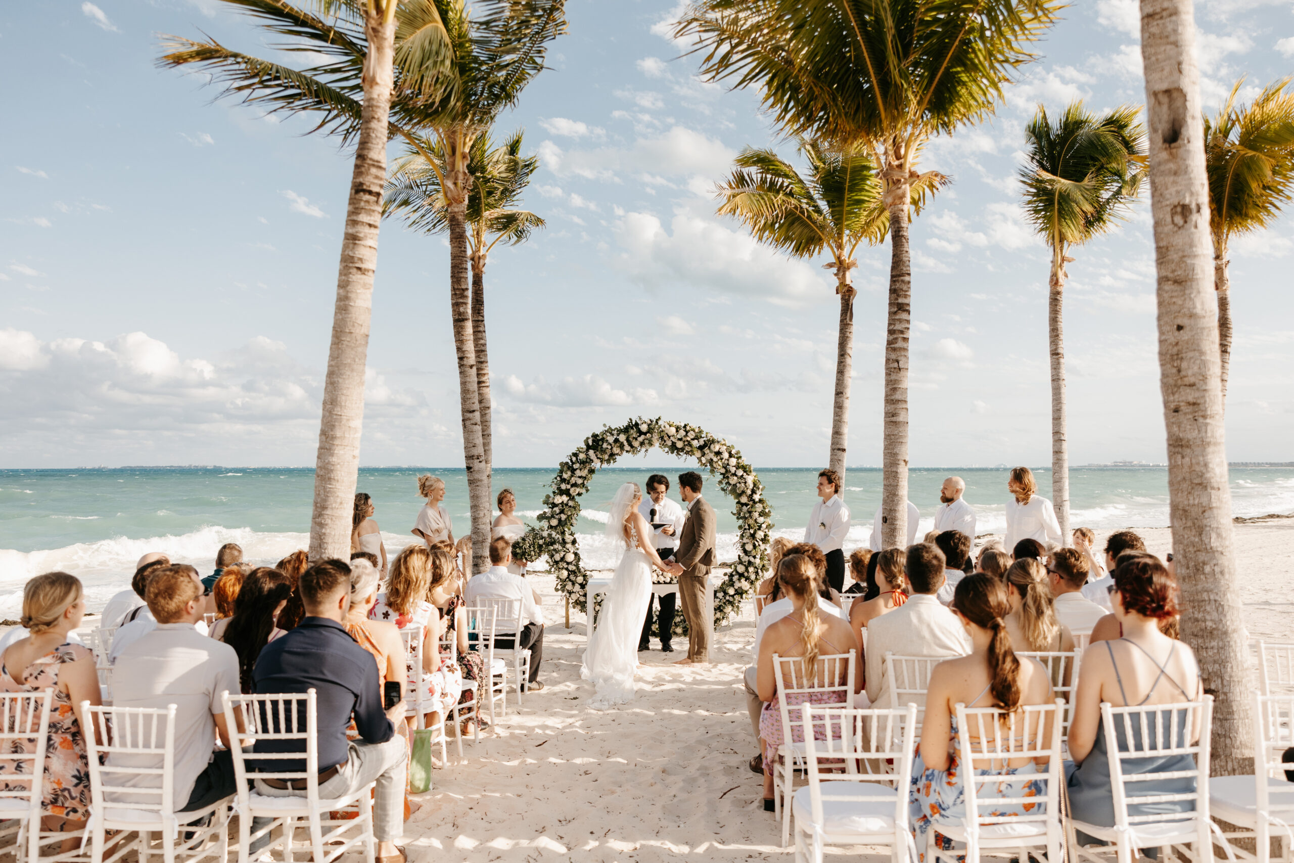 Breathtaking view of the ceremony setup overlooking the turquoise waters of Cancun - Destination wedding backdrop